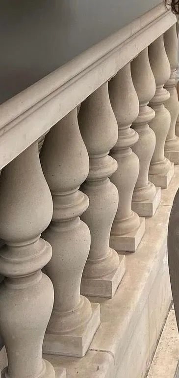 Hand-turned limestone balusters with a moulded handrail and plinth.