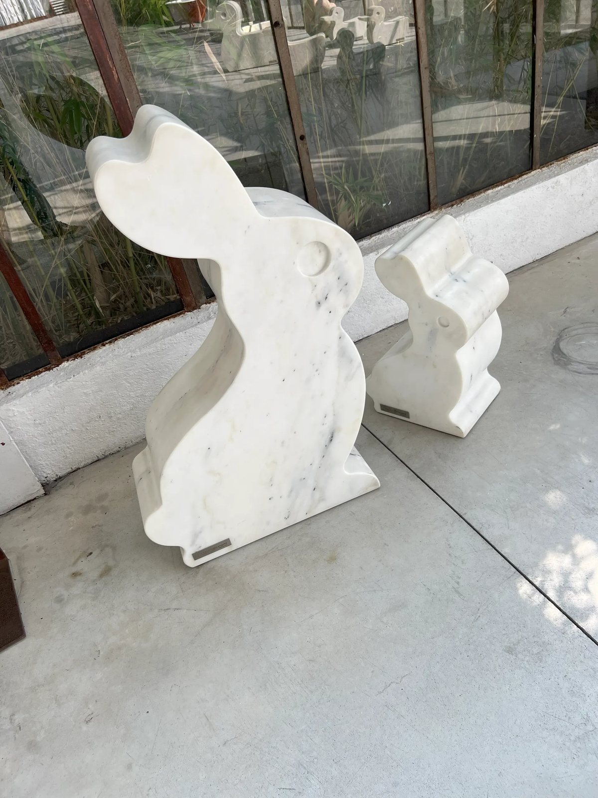 Playful rabbit sculptures cut from solid white marble for gardens and terraces.