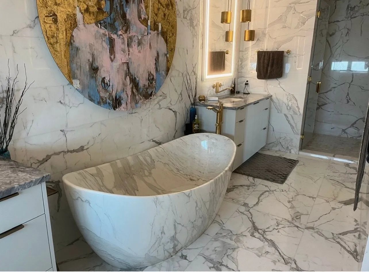 White marble bathroom with a freestanding marble tub