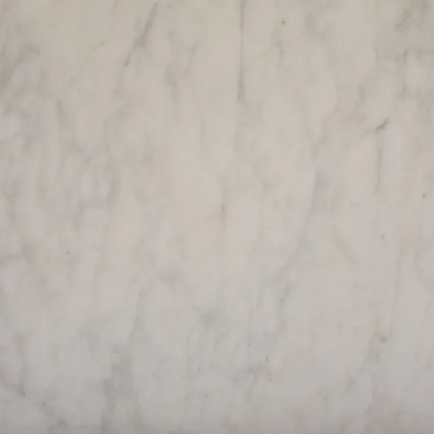 White Carrera italian marble tile — Soft white with gentle, cloudy grey veining.