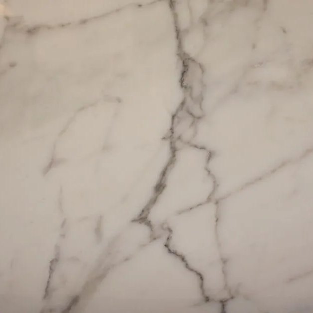 Calacatta Gold italian marble tile — Warm white with bold, dramatic grey-gold veining.