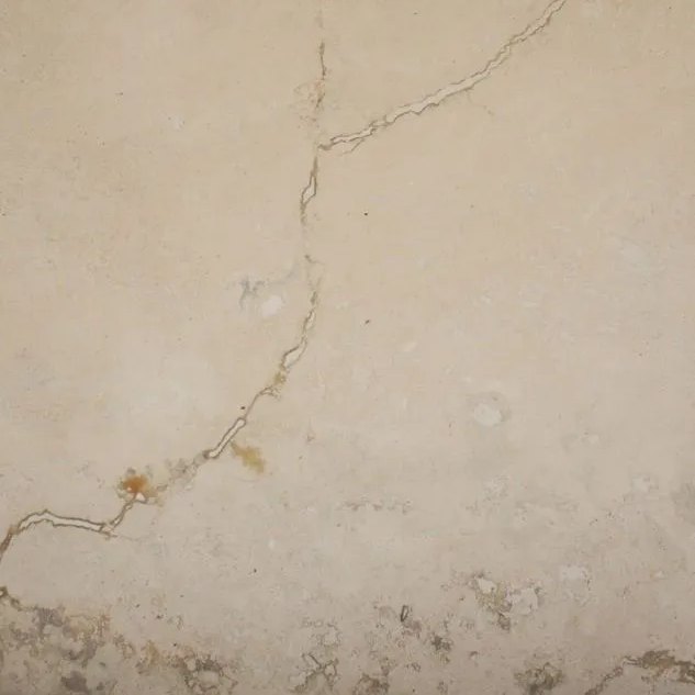 Novona Filled travertine tile — Soft cream with a striking natural vein line; filled surface.